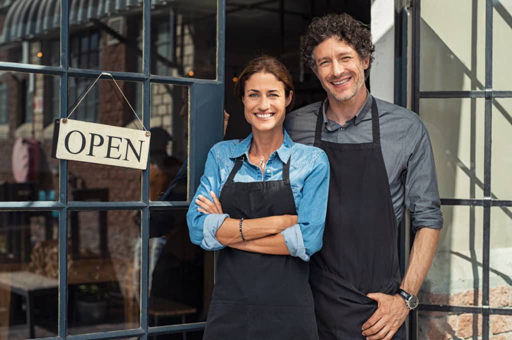 Two,Cheerful,Small,Business,Owners,Smiling,And,Looking,At,Camera - Prime Corporate Services DBA in California Candy Shop